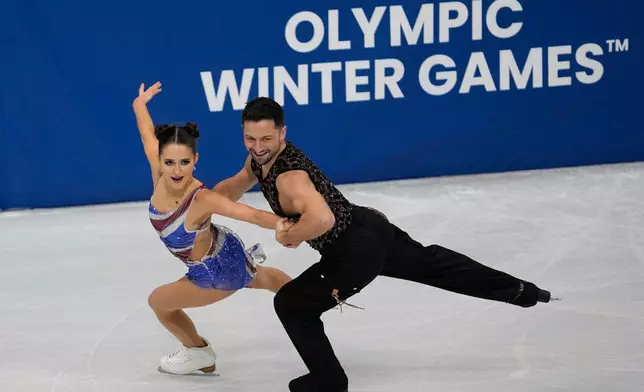 Lilah Fear and Lewis Gibson of Britain compete during the figure skating ice dance team event at the 2026 Winter Olympics, in Milan, Italy, Friday, Feb. 6, 2026. (AP Photo/Ashley Landis)