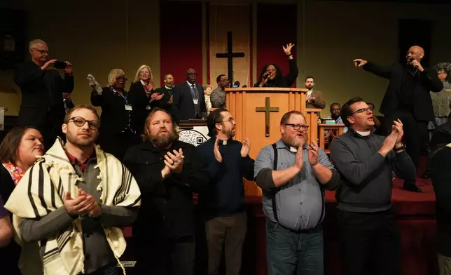 Faith leaders from across the United States sing together as a sign of support for Haitian migrants fearing the end of their Temporary Protected Status in the U.S., at an event held at St. John Missionary Baptist Church in Springfield, Ohio, on Monday, Feb. 2, 2026. (AP Photo/Luis Andres Henao)