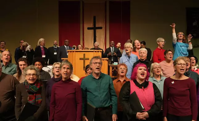 Faith leaders and members of the World House Choir sing at St. John Missionary Baptist Church in Springfield, Ohio, on Monday, Feb. 2, 2026, during an event in support of Haitian migrants fearing the end of their Temporary Protected Status in the U.S. (AP Photo/Luis Andres Henao)