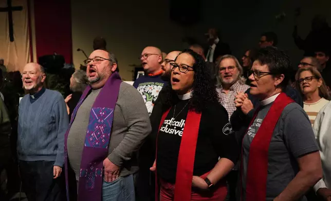 Faith leaders sing together as a sign of support for Haitian migrants fearing the end of their Temporary Protected Status in the U.S., at an event held at St. John Missionary Baptist Church in Springfield, Ohio on Monday, Feb. 2, 2026. (AP Photo/Luis Andres Henao)