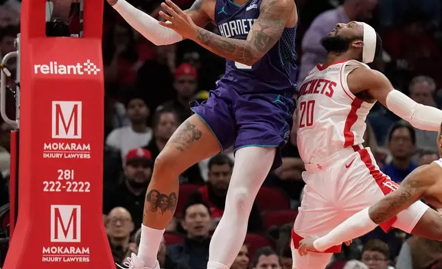 Charlotte Hornets forward Miles Bridges goes to the basket against Houston Rockets guard Josh Okogie (20) during the first half of an NBA basketball game, Thursday, Feb. 5, 2026, in Houston. (AP Photo/ Karen Warren)