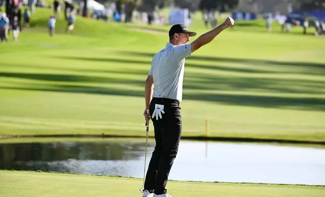 Justin Rose, of England, celebrates on the 18th green after winning the Farmers Insurance Open golf tournament Sunday, Feb. 1, 2026, at Torrey Pines in San Diego. (AP Photo/Denis Poroy)