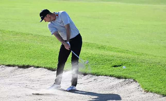 Justin Rose, of England, hits out of a bunker on the 17th hole of the South Course at Torrey Pines during the final round of the Farmers Insurance Open golf tournament Sunday, Feb. 1, 2026, in San Diego. (AP Photo/Denis Poroy)