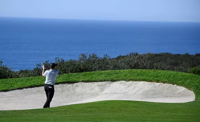 Justin Rose, of England, hits out of a bunker on the 14th hole of the South Course at Torrey Pines during the final round of the Farmers Insurance Open golf tournament Sunday, Feb. 1, 2026, in San Diego. (AP Photo/Denis Poroy)