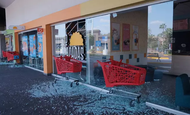 Carts stand outside of a vandalized supermarket in Guadalajara, Jalisco state, Mexico, Sunday, Feb. 22, 2026, after the death of the leader of the Jalisco New Generation Cartel, Nemesio Rubén Oseguera Cervantes, known as "El Mencho." (AP Photo/Alejandra Leyva)