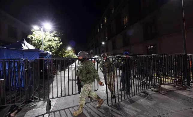Army soldiers patrol outside the National Palace ahead of the daily, morning news conference by Mexican President Claudia Sheinbaum in Mexico City, Monday, Feb. 23, 2026. (AP Photo/Ginnette Riquelme)