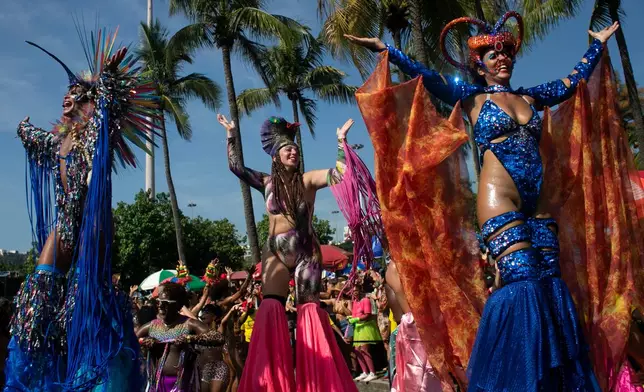 Stilt walkers perform during the Amigos da Onca Carnival street party in Rio de Janeiro, Saturday, Feb. 14, 2026. (AP Photo/Bruna Prado)