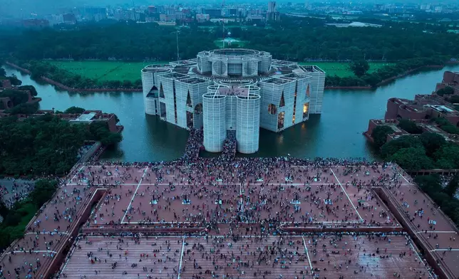 FILE - Protesters celebrate at the Parliament House premise after news of Prime Minister Sheikh Hasina's resignation, in Dhaka, Bangladesh, on Aug. 5, 2024. (AP Photo/Fatima Tuj Johora, File)