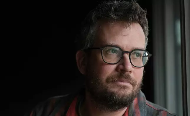 Writer John Green poses in his studio in Indianapolis, Wednesday, Jan. 21, 2026. (AP Photo/Michael Conroy)