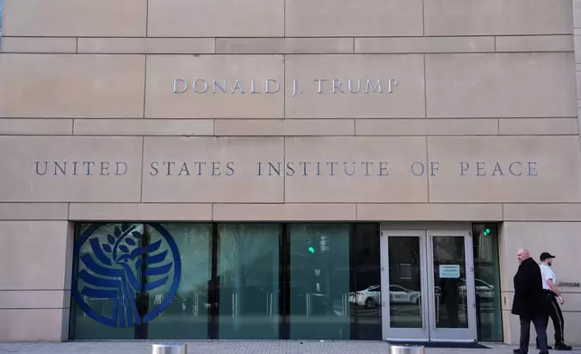 FILE - President Donald Trump's name is seen on the U.S. Institute of Peace building, Dec. 4, 2025, in Washington. (AP Photo/Evan Vucci, File)