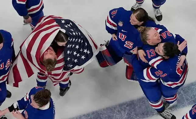 Team United States players celebrate after beating Canada 2-1 in overtime in the women's ice hockey gold medal game at the 2026 Winter Olympics, in Milan, Italy, Thursday, Feb. 19, 2026. (AP Photo/David J. Phillip)