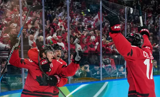 Canada's Nathan MacKinnon (29) celebrates with teammates after scoring his side's third goal during a men's ice hockey semifinal game between Canada and Finland at the 2026 Winter Olympics, in Milan, Italy, Feb. 20, 2026. (AP Photo/Petr David Josek, File)