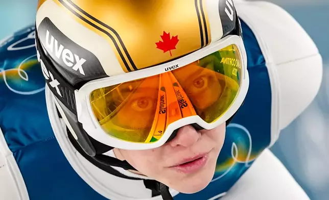 Nicole Maurer, of Canada, goes down the ramp during her trial jump of the ski jumping women's normal hill individual, at the 2026 Winter Olympics, in Predazzo, Italy, Feb. 7, 2026. (AP Photo/Matthias Schrader, File)