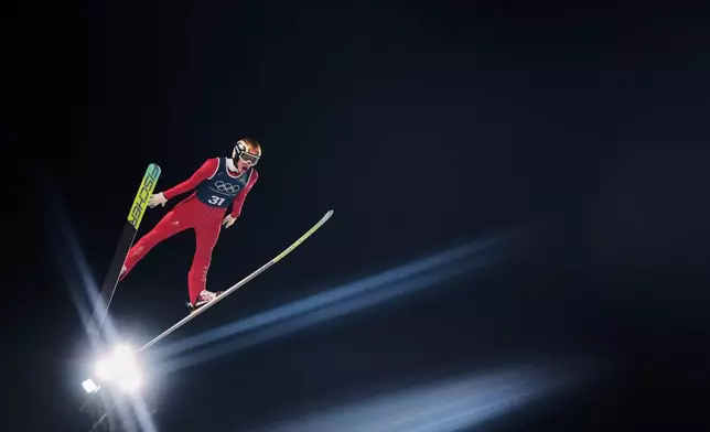 Gregor Deschwanden, of Switzerland, soars through the air during a ski jumping, men's normal hill, training session, at the 2026 Winter Olympics, in Predazzo, Italy, Feb. 8, 2026. (AP Photo/Kirsty Wigglesworth, File)
