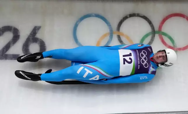 Italy's Dominik Fischnaller slides down the track during a men's single luge run at the 2026 Winter Olympics, in Cortina d'Ampezzo, Italy, Sunday, Feb. 8, 2026. (AP Photo/Aijaz Rahi)