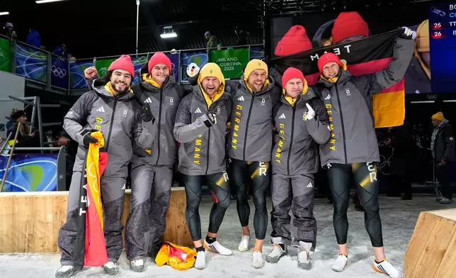 From left, Germany's bronze medalists Adam Ammour and Alexander Schaller, Germany's gold medalists Johannes Lochner and Georg Fleischhauer and Germany's silver medalists Francesco Friedrich and Alexander Schuller celebrate at the finish after the two man bobsled competition at the 2026 Winter Olympics, in Cortina d'Ampezzo, Italy, Tuesday, Feb. 17, 2026. (AP Photo/Alessandra Tarantino)