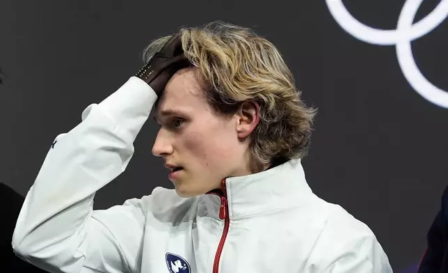 Ilia Malinin of the United States reacts after competing while waiting for scores during the men's free skate program in figure skating at the 2026 Winter Olympics, in Milan, Italy, Friday, Feb. 13, 2026. (AP Photo/Ashley Landis)