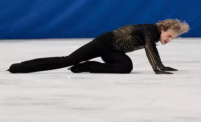 Ilia Malinin of the United States falls during the men's free skate program in figure skating at the 2026 Winter Olympics, in Milan, Italy, Friday, Feb. 13, 2026. (AP Photo/Ashley Landis)
