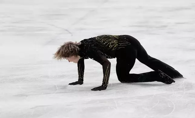Ilia Malinin of the United States falls during the men's free skate program in figure skating at the 2026 Winter Olympics, in Milan, Italy, Friday, Feb. 13, 2026. (AP Photo/Natacha Pisarenko)