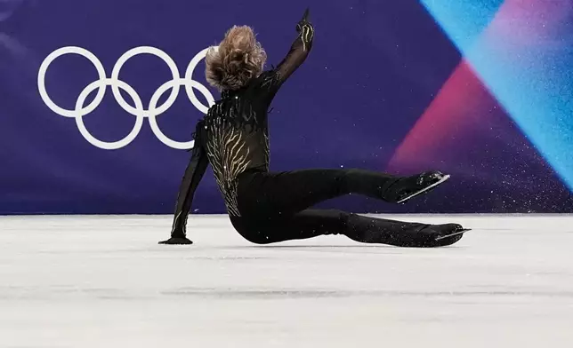 Ilia Malinin of the United States falls during the men's free skate program in figure skating at the 2026 Winter Olympics, in Milan, Italy, Friday, Feb. 13, 2026. (AP Photo/Ashley Landis)