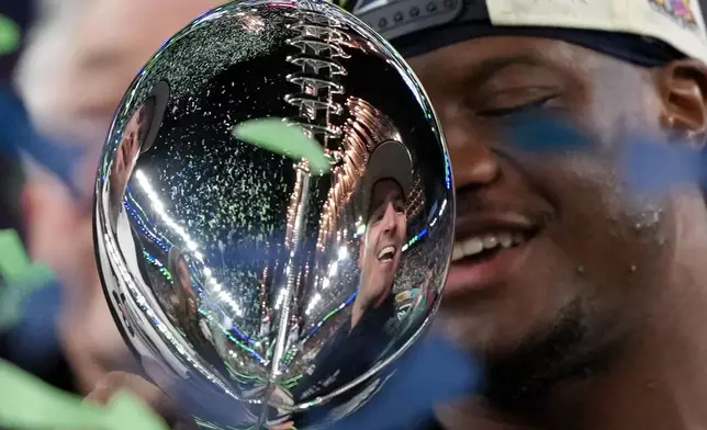 Seattle Seahawks head coach Mike MacDonald is reflected in the Lombardi Trophy after a win over the New England Patriots in the NFL Super Bowl 60 football game Sunday, Feb. 8, 2026, in Santa Clara, Calif. (AP Photo/Matt Slocum)
