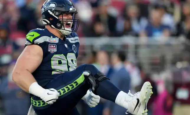 Seattle Seahawks defensive end Rylie Mills celebrates after sacking New England Patriots quarterback Drake Maye during the first half of the NFL Super Bowl 60 football game, Sunday, Feb. 8, 2026, in Santa Clara, Calif. (AP Photo/Brynn Anderson)