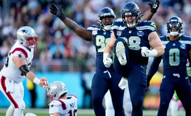 Seattle Seahawks defensive end Rylie Mills (98) celebrates after sacking New England Patriots quarterback Drake Maye during the first half of the NFL Super Bowl 60 football game, Sunday, Feb. 8, 2026, in Santa Clara, Calif. (AP Photo/Sue Ogrocki)