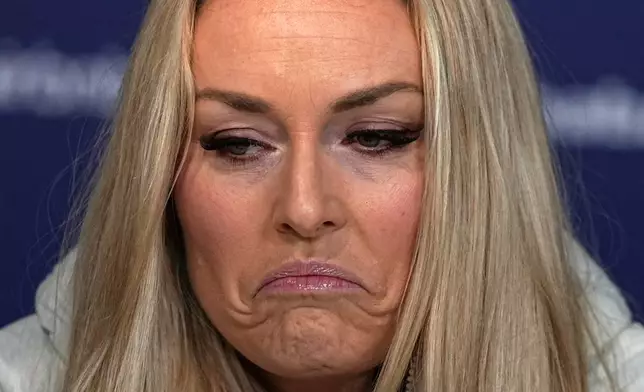 United States' Lindsey Vonn grimaces during a press conference by the U.S. ski team at the 2026 Winter Olympics, in Cortina d'Ampezzo, Italy, Tuesday, Feb. 3, 2026. (AP Photo/Fatima Shbair)