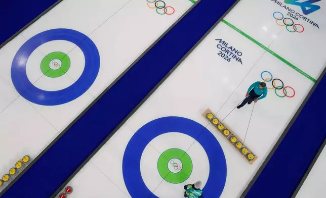 Preparations for the first curling competition are made at the 2026 Winter Olympics in Cortina d'Ampezzo, Italy, Wednesday, Feb. 4, 2026. (AP Photo/David J. Phillip)