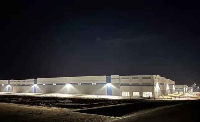 Three hulking warehouses light up the night in Socorro, Texas, Thursday, Feb. 12, 2026, amid concern about the purchase of the property by federal authorities in connection with U.S. Immigration and Customs Enforcement’s $45-billion expansion of immigrant detention centers. (AP Photo/Morgan Lee)