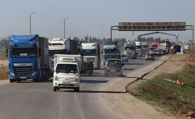 A convoy carrying U.S. Army vehicles drives away from the International Coalition's Qasrak Base, its largest base in northeastern Syria, heading toward Iraqi territory on the outskirts of Qamishli, eastern Syria, Monday, Feb. 23, 2026.(AP Photo/Baderkhan Ahmad)