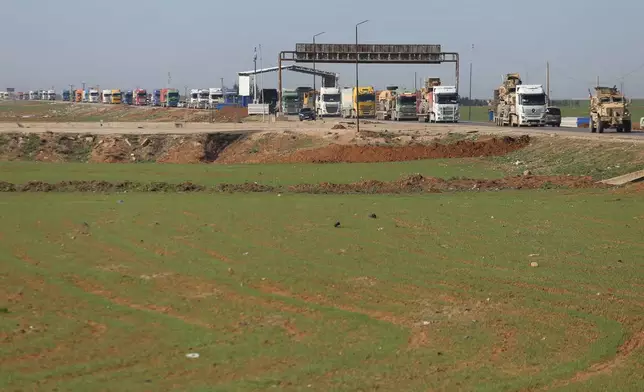 A convoy carrying U.S. Army vehicles drives away from the International Coalition's Qasrak Base, its largest base in northeastern Syria, heading toward Iraqi territory on the outskirts of Qamishli, eastern Syria, Monday, Feb. 23, 2026.(AP Photo/Baderkhan Ahmad)
