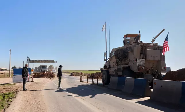 A convoy carrying U.S. Army vehicles drives away from the International Coalition's Qasrak Base, its largest base in northeastern Syria, heading toward Iraqi territory on the outskirts of Qamishli, eastern Syria, Monday, Feb. 23, 2026.(AP Photo/Baderkhan Ahmad)