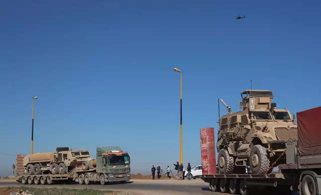 A convoy carrying U.S. Army vehicles drives away from the International Coalition's Qasrak Base, its largest base in northeastern Syria, heading toward Iraqi territory on the outskirts of Qamishli, eastern Syria, Monday, Feb. 23, 2026.(AP Photo/Baderkhan Ahmad)