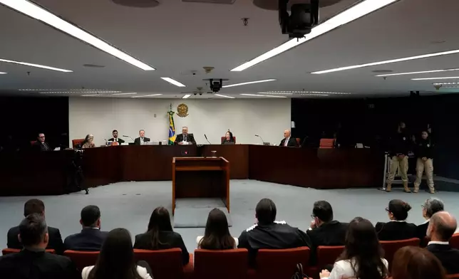 Judge Flavio Dino, center top, presides over the first day of trial of those accused of ordering the murder of councilwoman Marielle Franco at the Supreme Court in Brasilia, Brazil, Tuesday, Feb. 24, 2026. (AP Photo/Eraldo Peres)