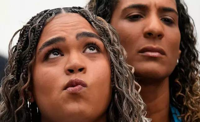 Luyara Franco, daughter of late councilwoman Marielle Franco, and her aunt Anielle Franco give a press conference at the Supreme Court before the start of the first day of trial of those accused of ordering Marielle's murder, in Brasilia, Brazil, Tuesday, Feb. 24, 2026. (AP Photo/Eraldo Peres)