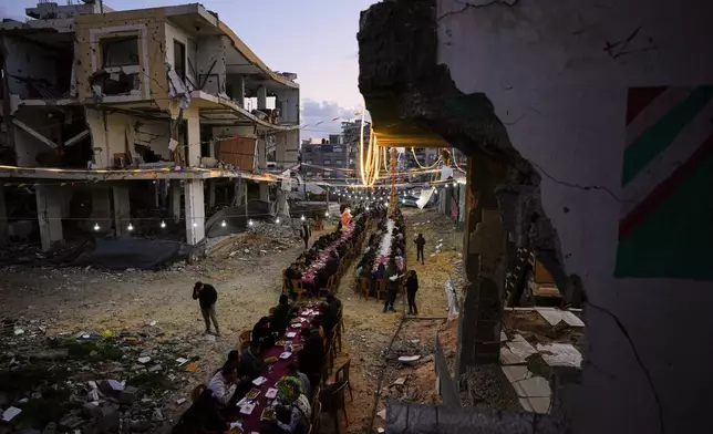 Palestinians gather for iftar, the fast-breaking meal, during the Muslim holy month of Ramadan amid the rubble of destroyed buildings in Gaza City, Thursday, Feb. 26, 2026. (AP Photo/Abdel Kareem Hana)