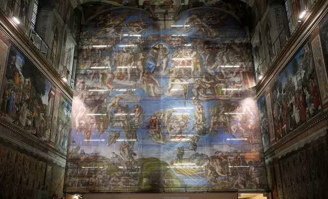 A screen with a replica of “The Last Judgment,” superimposed on it covers the scaffolding used for its extraordinary maintenance during a presentation for press in the Sistine Chapel at the Vatican, Saturday, Feb. 28, 2026. (AP Photo/Alessandra Tarantino)