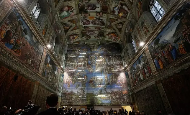 A screen with a replica of “The Last Judgment,” superimposed on it covers the scaffolding used for its extraordinary maintenance during a presentation for press in the Sistine Chapel at the Vatican, Saturday, Feb. 28, 2026. (AP Photo/Alessandra Tarantino)