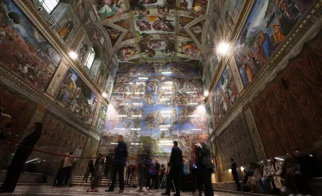A screen with a replica of “The Last Judgment,” superimposed on it covers the scaffolding used for its extraordinary maintenance during a presentation for press in the Sistine Chapel at the Vatican, Saturday, Feb. 28, 2026. (AP Photo/Alessandra Tarantino)