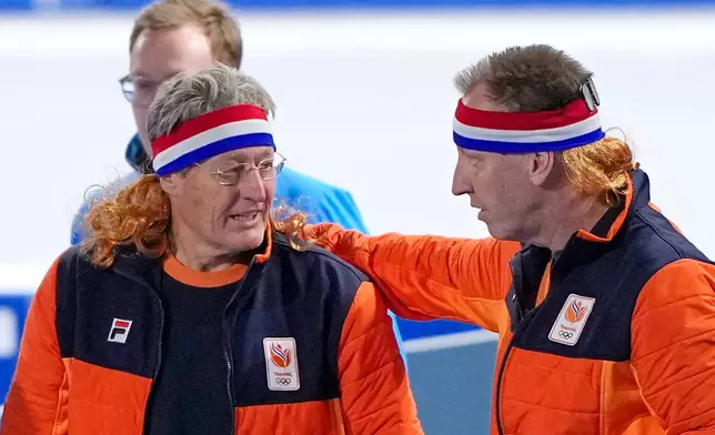 Dutch coach Jillert Anema wears a mullet honouring the bronze medal of Jorrit Bergsma of the Netherlands after the men's 10,000 meters speedskating race at the 2026 Winter Olympics, in Milan, Italy, Friday, Feb. 13, 2026. (AP Photo/Ben Curtis)