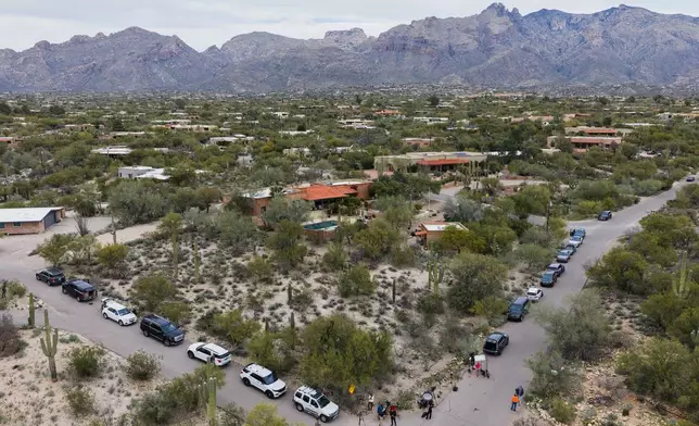Members of the press work in the neighborhood near the home of Nancy Guthrie, the missing mother of “Today” show host Savannah Guthrie, Thursday, Feb. 5, 2026, in Tucson, Ariz. (AP Photo/Caitlin O'Hara)
