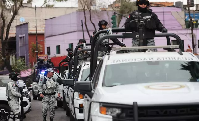 National Guards patrol the area outside of the General Prosecutor's headquarters in Mexico City, Sunday, Feb. 22, 2026, after authorities reported that the Mexican Army killed Jalisco New Generation Cartel leader Nemesio Oseguera, known as "El Mencho." (AP Photo/Ginette Riquelme)