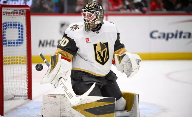 Vegas Golden Knights goaltender Akira Schmid looks for the puck during the first period of an NHL hockey game against the Washington Capitals, Friday, Feb. 27, 2026, in Washington. (AP Photo/Nick Wass)