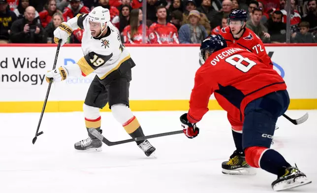 Vegas Golden Knights right wing Reilly Smith (19) shoots the puck past Washington Capitals left wing Alex Ovechkin (8) during the second period of an NHL hockey game, Friday, Feb. 27, 2026, in Washington. (AP Photo/Nick Wass)