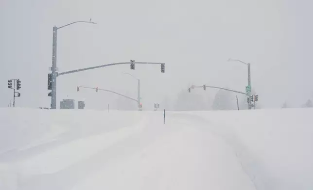 A road is covered in snow during a storm on Tuesday, Feb. 17, 2026 in Truckee Calif. (AP Photos/Brooke Hess-Homeier)