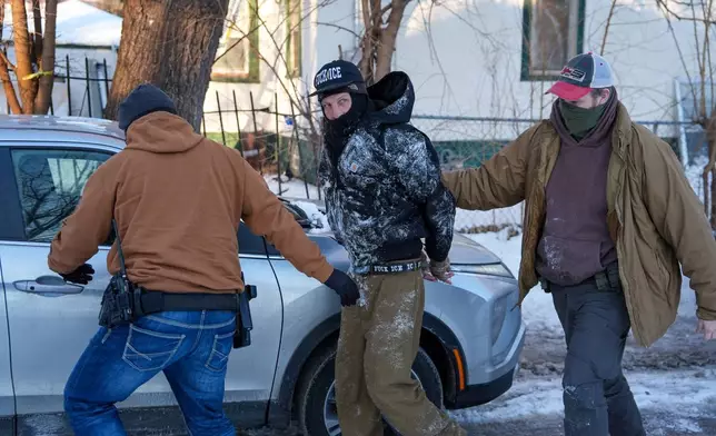 An activist is detained by federal agents on Tuesday, Feb. 3, 2026, in Minneapolis. (AP Photo/Ryan Murphy)