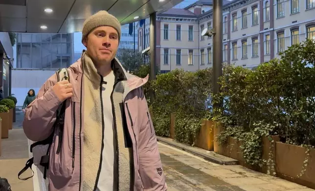 Norwegian skier Nikolai Schirmer walks out of a Milan hotel, Wednesday, Feb. 4, 2026, after privately meeting with the IOC's head of sustainability, Julie Duffus, to hand her a “ski fossil free” petition with over 20,000 signatures two days before the Opening Ceremony for the 2026 Milan Cortina Winter Olympics. (AP Photo/Fernanda Figueroa)