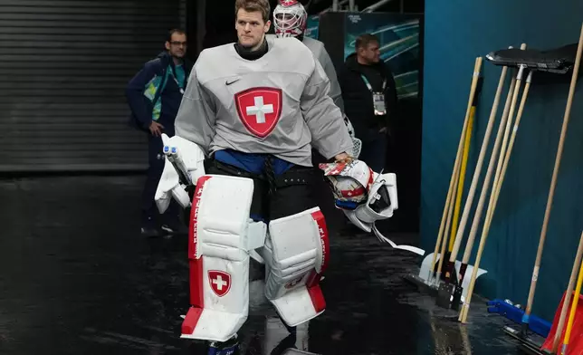 Switzerland's goalkeeper Leonardo Genoni arrives for men's ice hockey practice at the 2026 Winter Olympics, in Milan, Italy, Sunday, Feb. 8, 2026. (AP Photo/Carolyn Kaster)