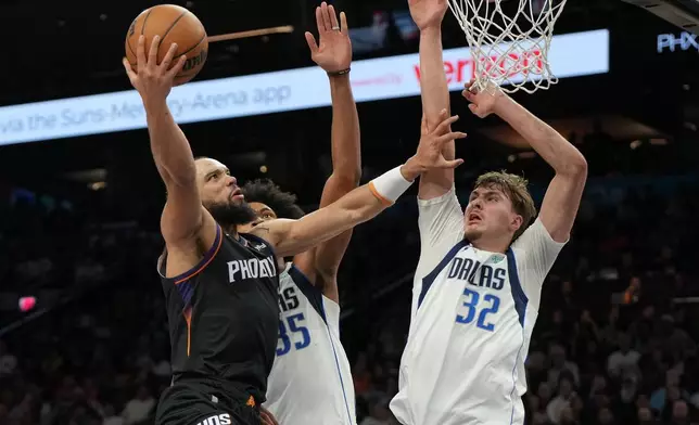 Phoenix Suns forward Dillon Brooks shoots over Dallas Mavericks forward Marvin Bagley III and forward Cooper Flagg (32) during the second half of an NBA basketball game, Tuesday, Feb. 10, 2026, in Phoenix. (AP Photo/Rick Scuteri)